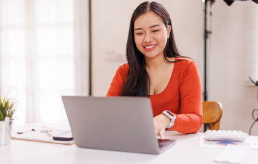 asian woman entrepreneur working, business woman or journalist using laptop computer at home....