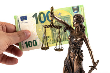 A figurine of Themis and a 100 euro banknote in a man's hand