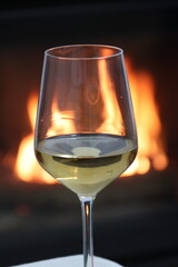 Glasses of white wine by the fireplace