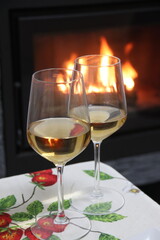Glasses of white wine by the fireplace
