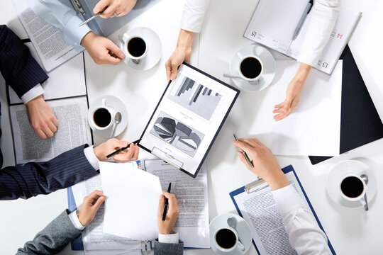 Project Management, Executive Decision-Making, and Modern Office Dynamics Depicted Through Stock Photography Illustrating Individuals in Professional Attire, Engaged in Tasks Such as Using Laptops, Ta