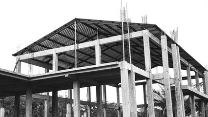 Monochrome image of building construction site featuring concrete structure.