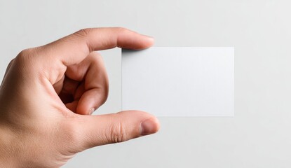 Hand holding a blank business card