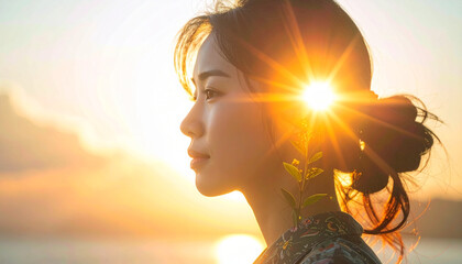 A woman bathed in the golden light of sunset , Serene portrait of a woman with a plant in golden hour light