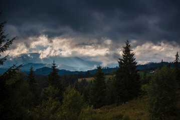 Dramatic Sky Over Forested Mountain Landscape