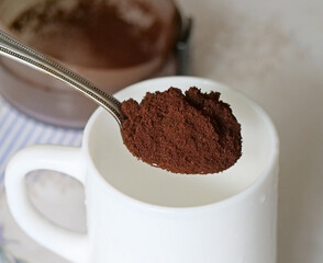 Preparing to brew fresh coffee - Ground coffee in a measuring spoon