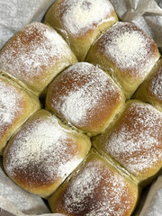 Homemade matcha bread rolls with flour dusting freshly baked