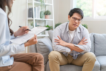 Man talking with mentor psychologist in therapy mental health anxiety session.