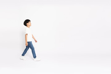 Asian little boy walking isolated on white background, Full body composition and eight years old