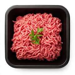 Fresh ground beef in a black tray, ready for cooking and a sprig of fresh parsley. This image represents the essential ingredient for a delicious meal
