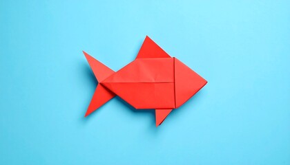 Red origami fish on a light-blue background