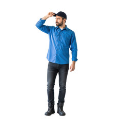 Fototapeta premium A man in a blue shirt and black pants standing against a white background.