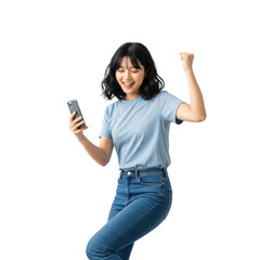 A young woman in a blue shirt and jeans is holding a smartphone and cheering with her fist raised.