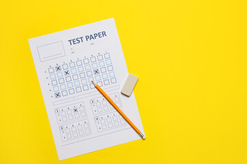 Student passing exam. Answer sheet, pencil and eraser on yellow background, flat lay. Space for text