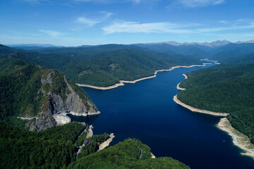Aerial drone panorama view of Vidraru dam and lake in Fagaras mountains, Romania.