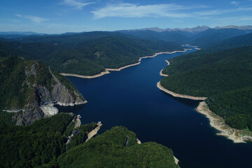 Aerial drone panorama view of Vidraru dam and lake in Fagaras mountains, Romania.