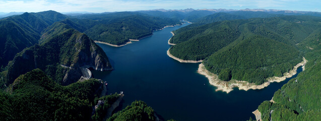 Aerial drone panorama view of Vidraru dam and lake in Fagaras mountains, Romania.