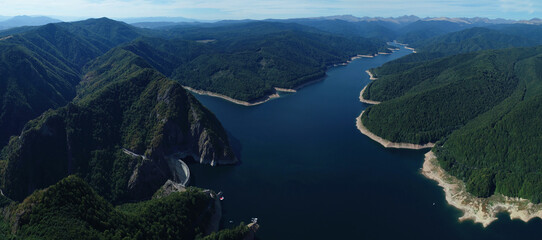 Aerial drone panorama view of Vidraru dam and lake in Fagaras mountains, Arges,Romania.