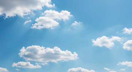 Fototapeta premium Blue sky with fluffy white clouds on a bright sunny day.