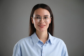 Portrait of confident businesswoman on grey background
