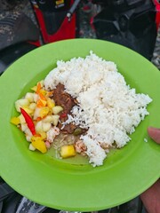 Delicious Traditional Meal with Steamed Rice, Savory Meat Curry, and Fresh Tangy Pickles