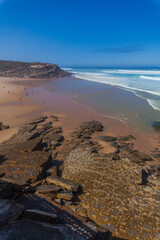 A stunning coastal scene with turquoise waves crashing onto a ro