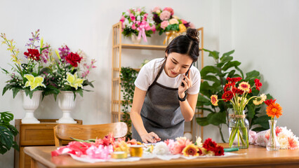 Adult Florist Woman Taking Order on Phone Call Working with Flowers Preparing Floral Arrangement for Delivery Flower Shop Business
