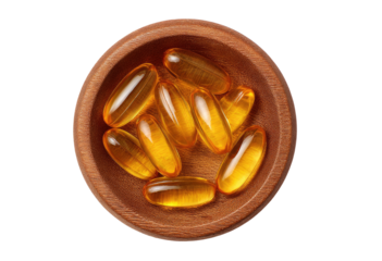 Small wooden bowl filled with translucent, golden-yellow capsules
