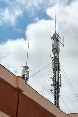 Telecommunications antennas on a building rooftop.
