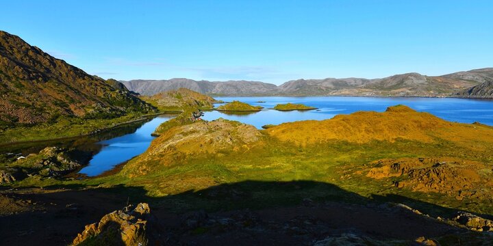 Scenic view of the fjord (Barents Sea) surrounded by mountains seen in the evening near Skipsfjord - Nordkapp Camping (Nordkapp municipality, Finnmark county, Norway)