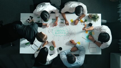 Top view of professional business team working together to brainstorm environmental idea by using mind map. Aerial view of smart manager talking and discussing about sustainable energy. Alimentation.