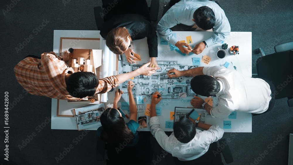 Poster top aerial view of project manager or civil engineer writing at blueprint and planning building desi