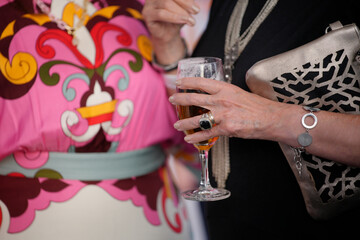 Woman holding a glass of beer at a social event