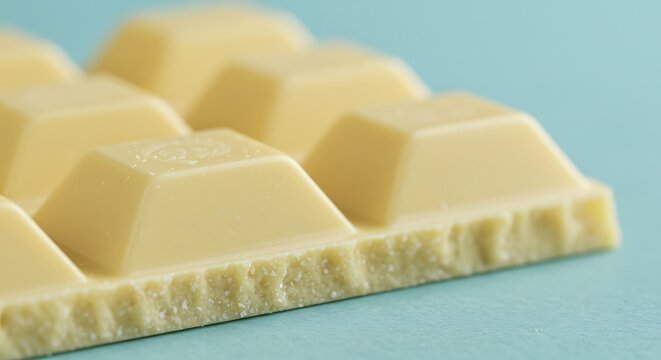 Delicious White Chocolate Bar on Blue Background.