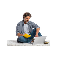Mature Man Working from Home, Focused on Laptop and Notebook