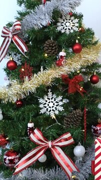 Vertical Under a modern Christmas tree, elegantly wrapped gift boxes enhance the holiday ambiance in a home, alongside holiday Xmas ornaments, as a design element for New Year decor. 