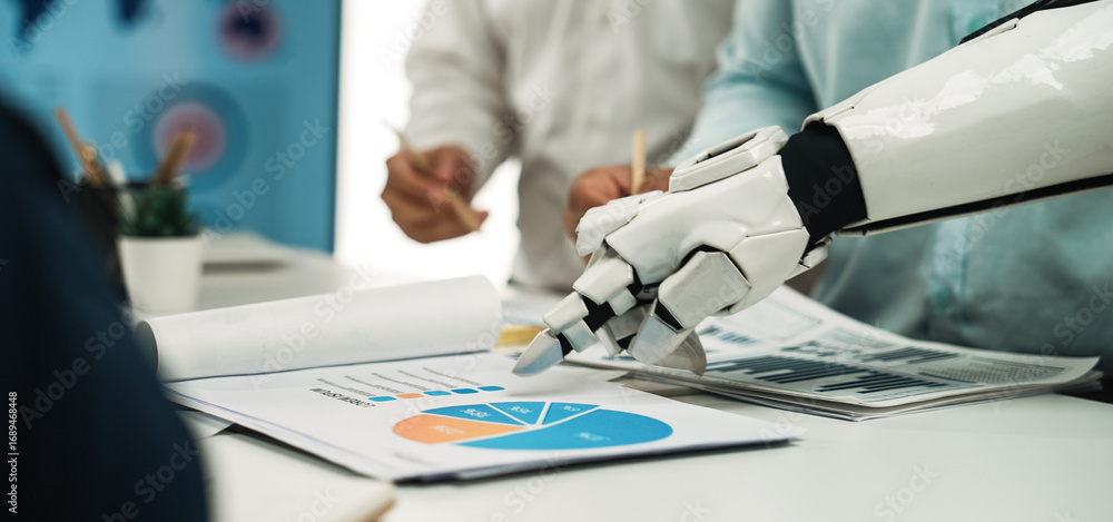 Poster a robotic hand points to business charts in a modern office setting, showcasing the intersection of 