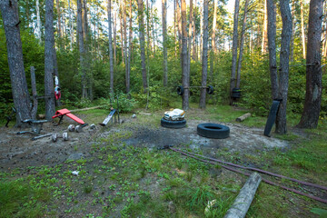 A homemade gym, set up right in the middle of the forest. Various devices for doing sports,...
