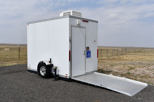 Portable outdoor toilet. Handicap accessible. Trailer unit with mounted AC.