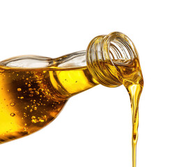 Golden liquid pouring from glass bottle