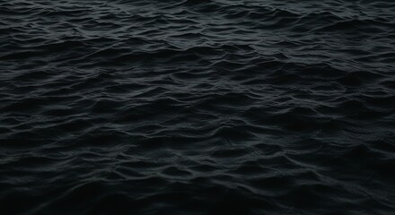 Dark ocean water surface with small waves.