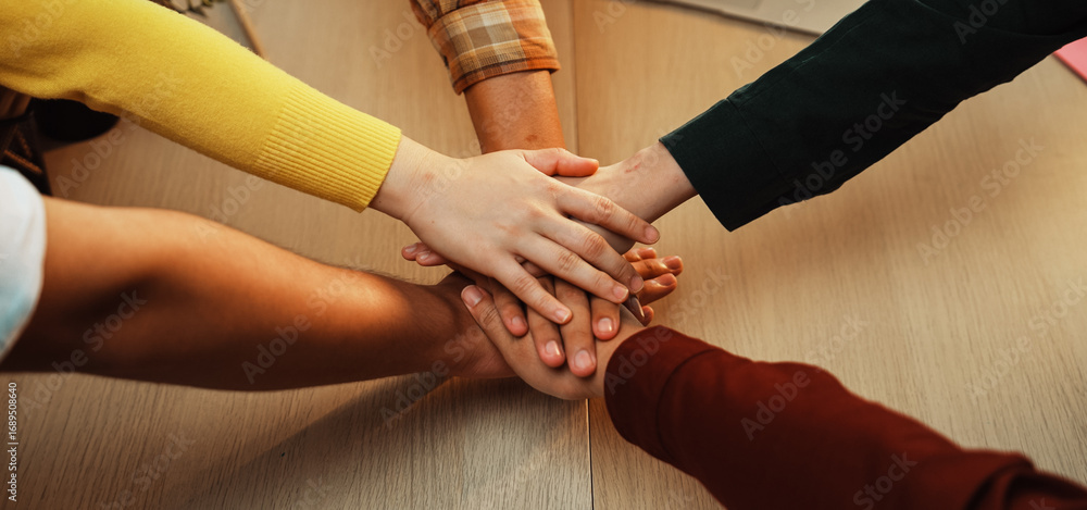 Aufkleber a group of diverse individuals joins hands in a unified gesture, symbolizing teamwork and support in