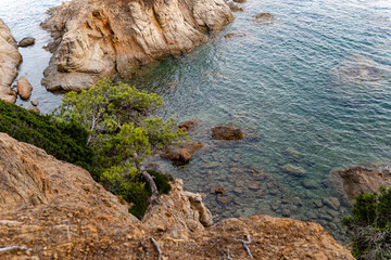 Beautiful rocky coast of Fenals in Lloret de Mar, featuring turquoise waters, rugged cliffs, and...