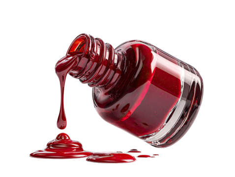 Red nail polish spilling from bottle