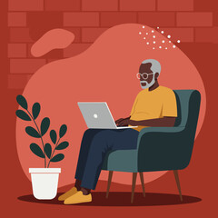 Senior Black man comfortably working on his laptop at home. Modern digital lifestyle, remote work, and technology integration for older adults.