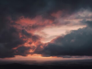 Naklejka premium Dramatic sunset paints the sky with vibrant pink and orange hues above a serene landscape