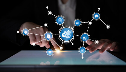 A business professional engages with innovative technology, analyzing key performance indicators through interactive data visualizations on a sleek touchscreen surface. Tessel
