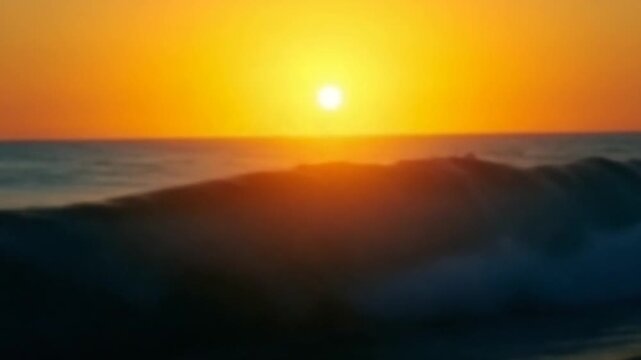 Blurred golden sea at sunset. The sun reflects and sparkles on the waves with bokeh, illuminating the golden sea. Holiday recreation concept. Abstract nautical summer ocean sunset nature background.