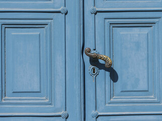 blue old historic double door with an ornate door handle and a keyhole