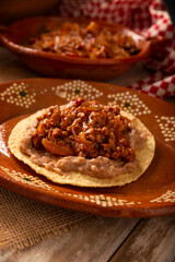 Ground beef tinga toast, a traditional Mexican home-cooked dish consisting primarily of beef cooked with chipotle chili and lots of onion, is traditionally eaten on 